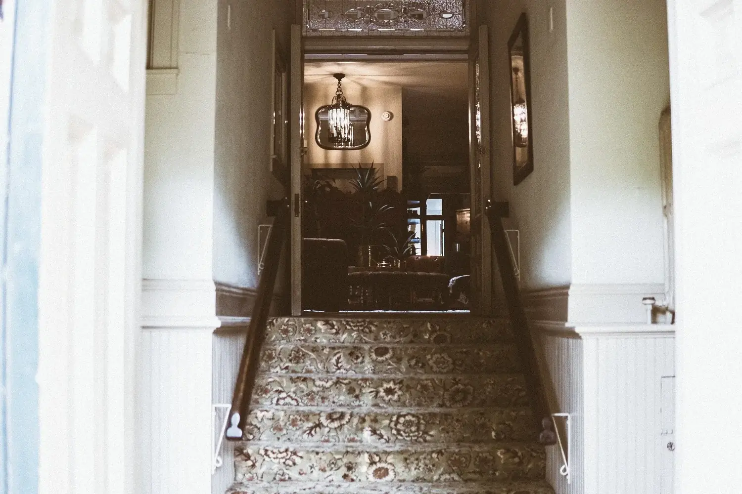The Old Ruth grand staircase and chandelier — historic executive housing in La Porte, Indiana