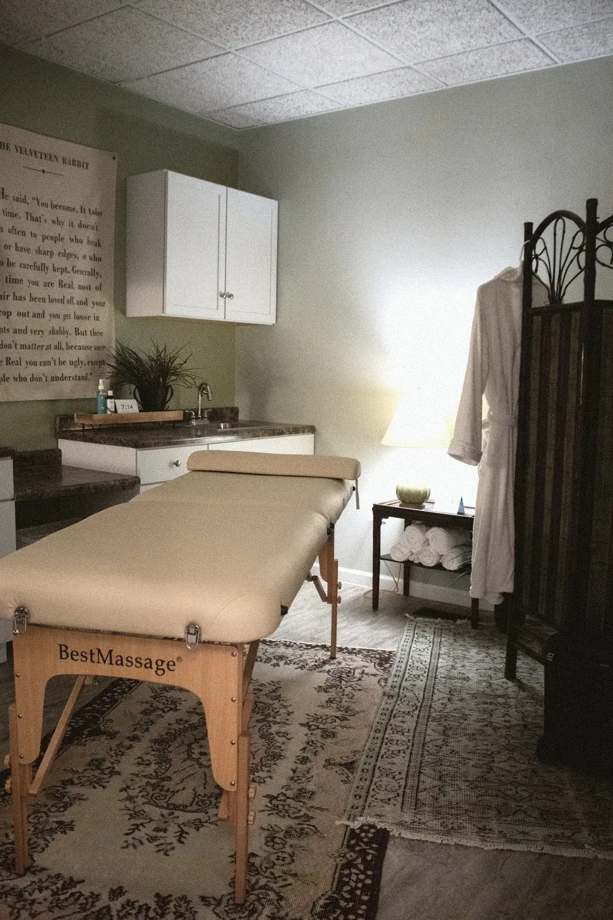 Spa treatment room with massage table and robe — wellness services for executive residents at The Old Ruth