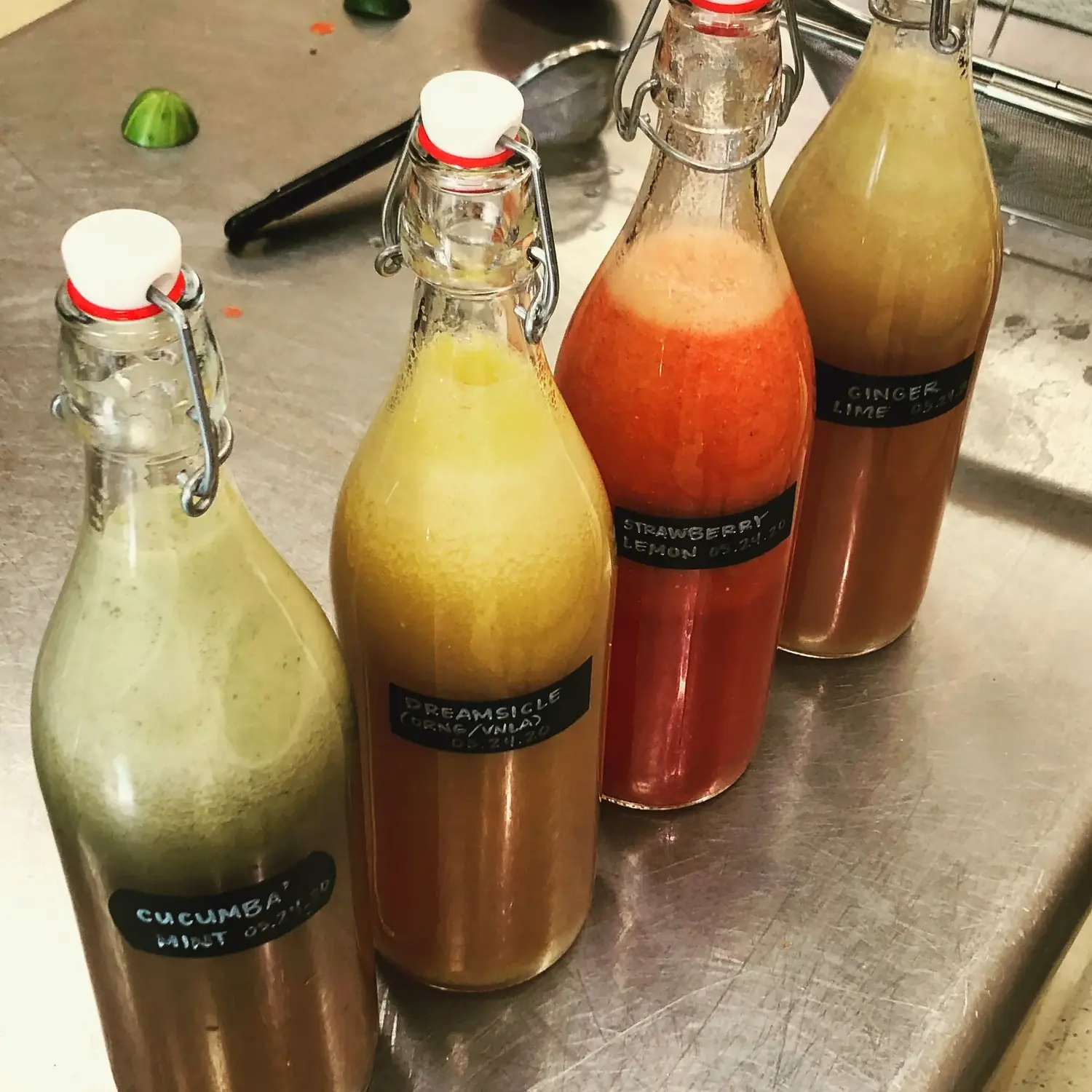 Homemade kombucha in swing-top bottles at The Old Ruth — cucumber mint, dreamsicle, strawberry lemon, ginger lime