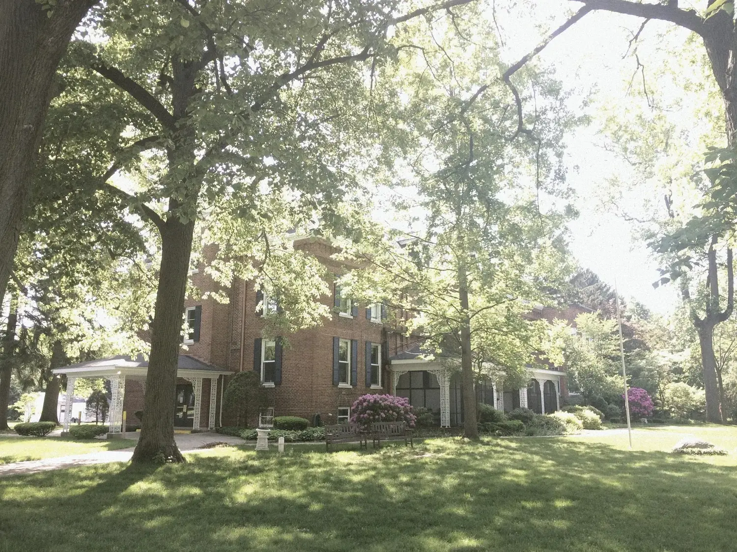 The Old Ruth — red brick historic mansion through mature trees, La Porte, Indiana