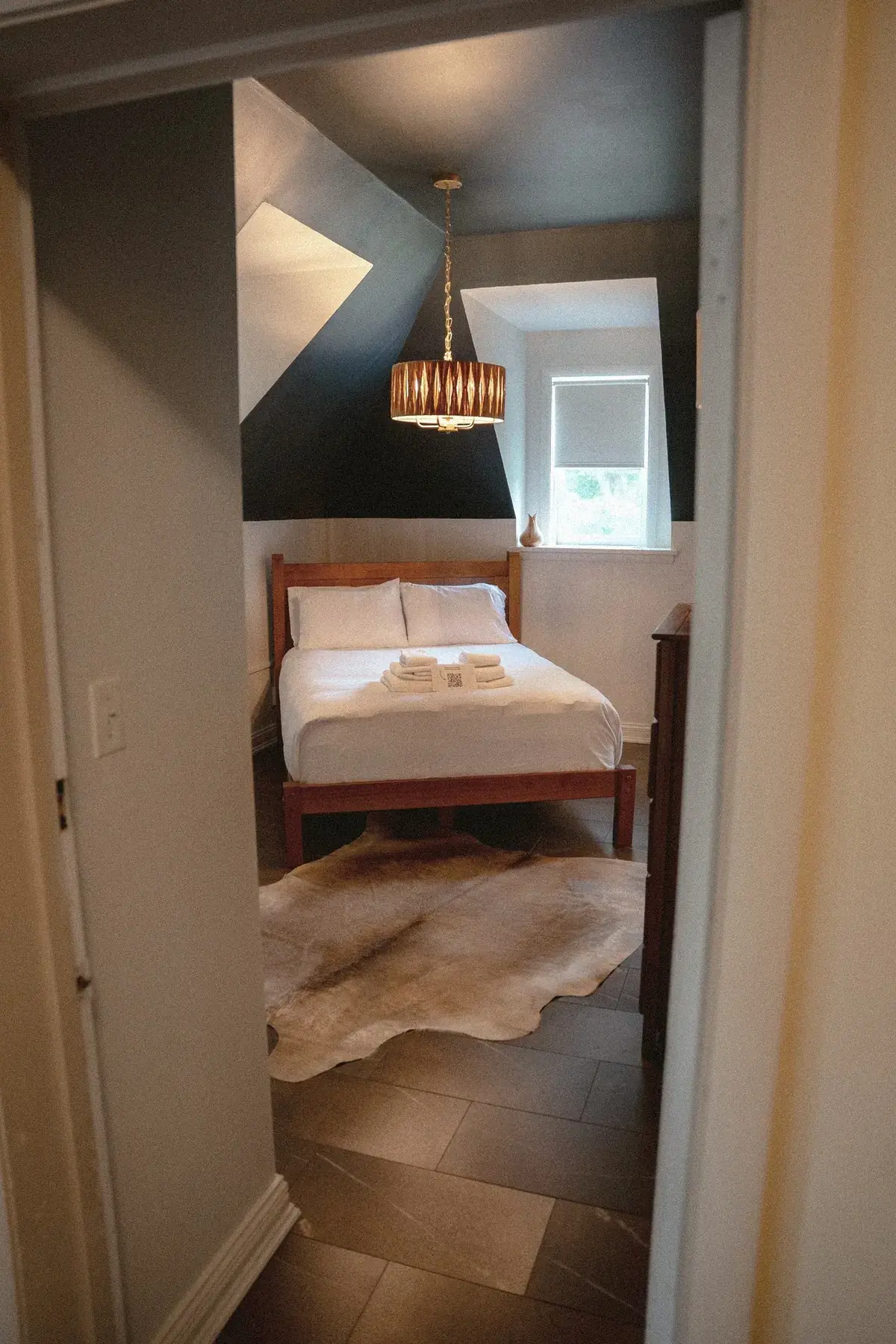 Compact black-and-white bedroom at The Old Ruth seen through the doorway