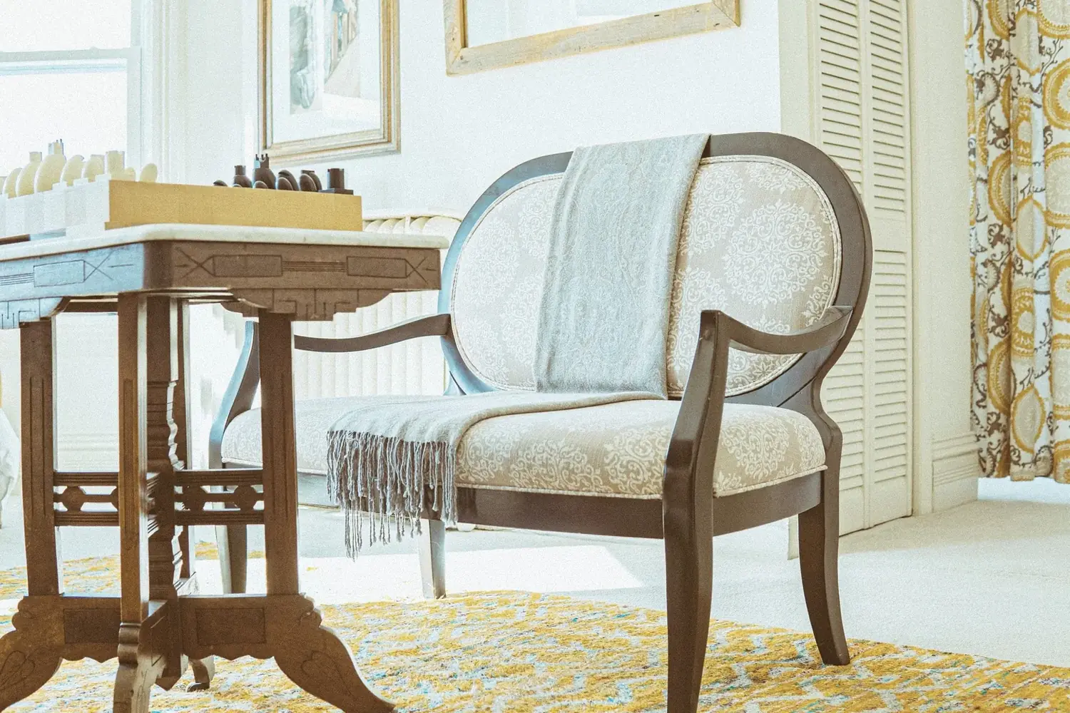 Game table with golden rug and patterned drapery at The Old Ruth