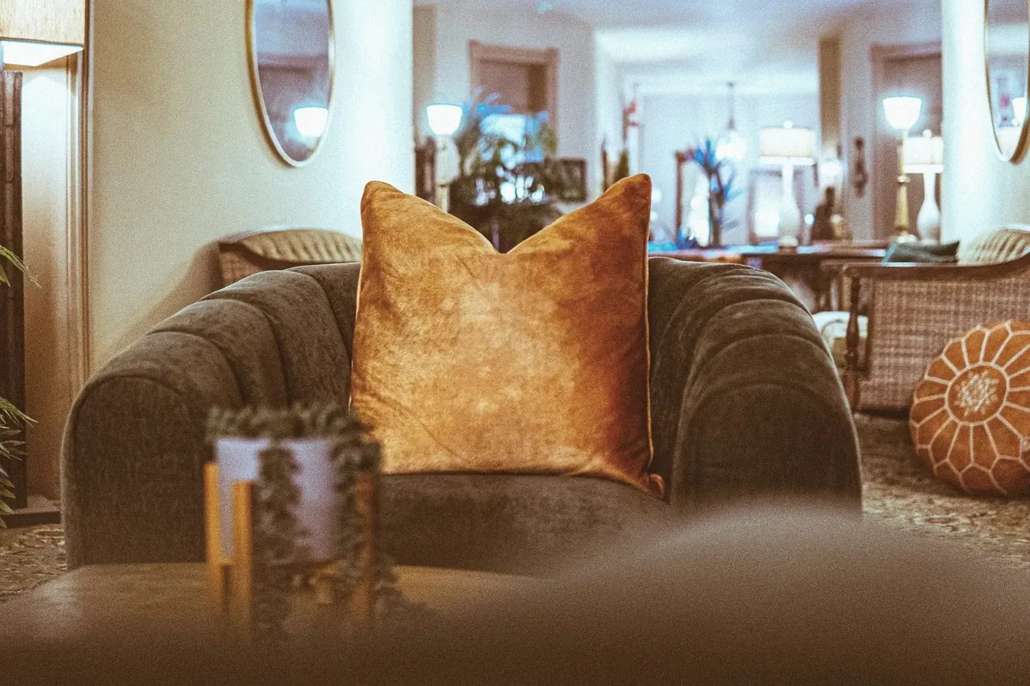 Plush armchair with amber pillow and soft lamp at The Old Ruth