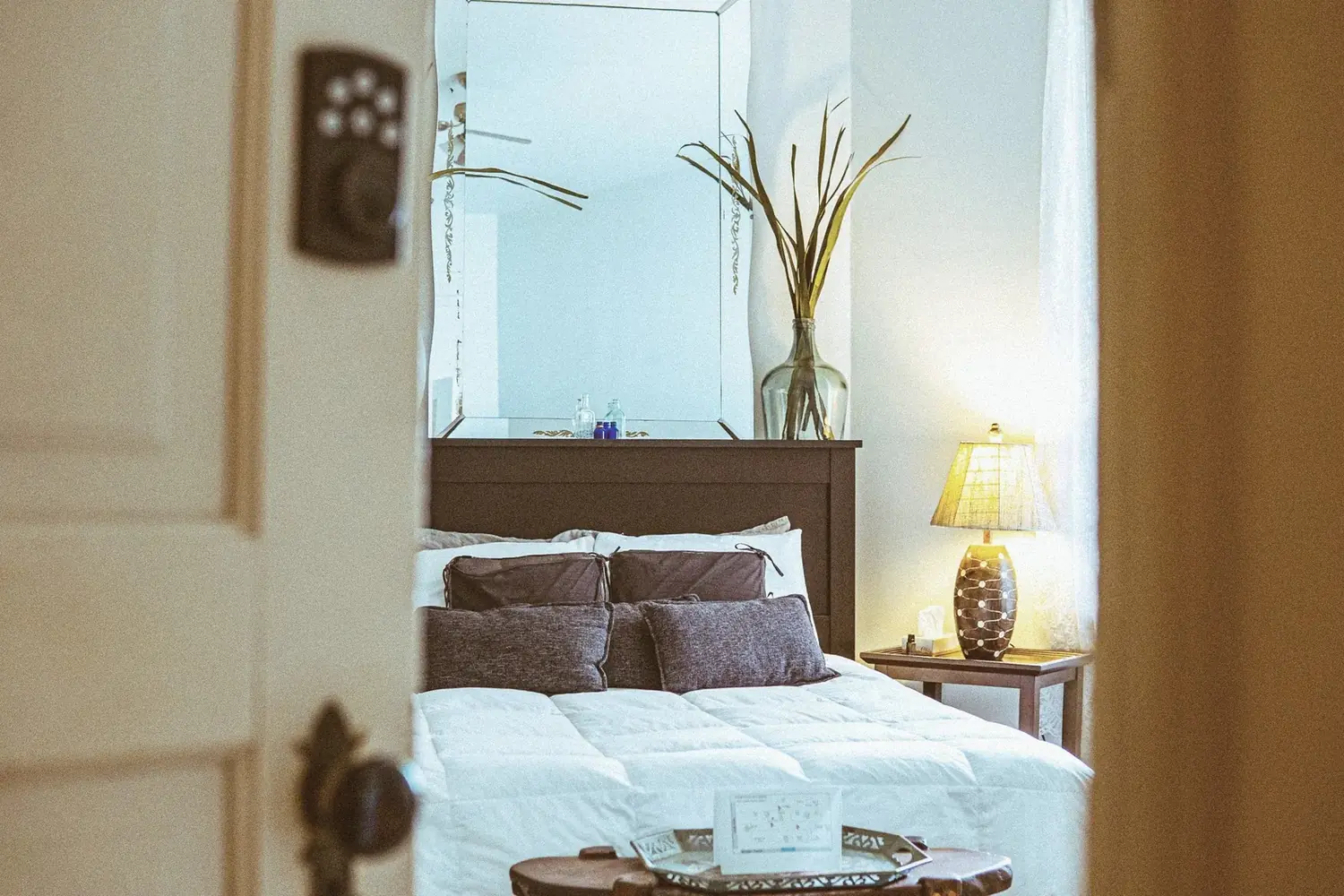 Private bedroom suite at The Old Ruth with warm lamp glow — furnished executive housing in La Porte