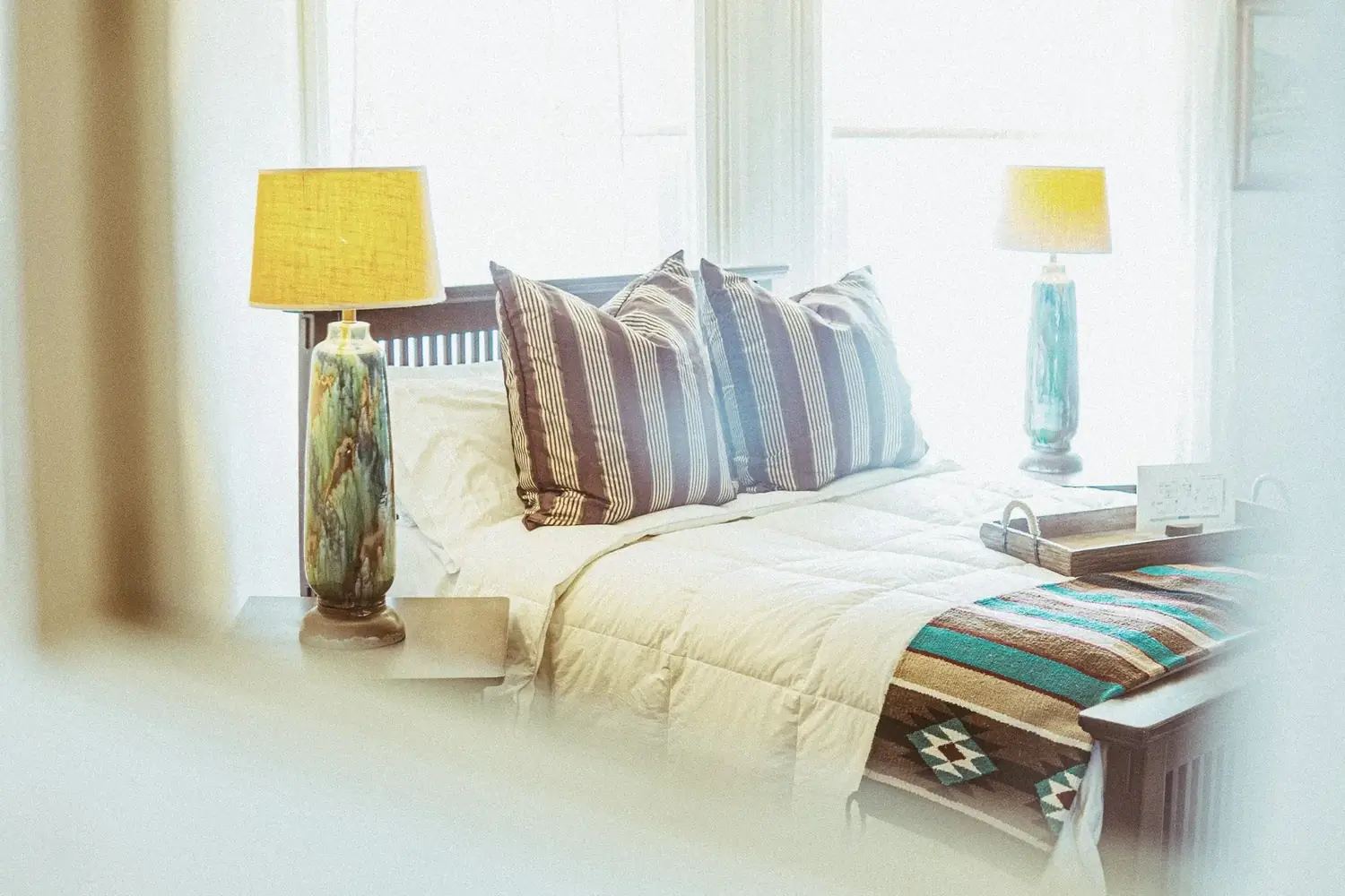 Furnished bedroom with glowing lamps at The Old Ruth corporate housing
